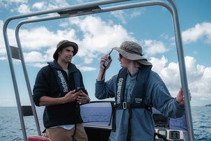 Man on a boat using a handheld, waterproof radio