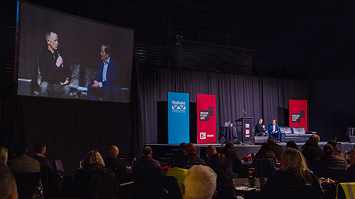 Image of several people sitting and talking on stage