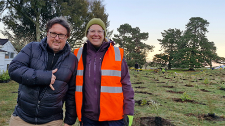 Image of two people standing together on a field