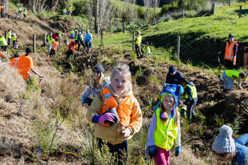 Te Poi students planting on neighbouring fram.